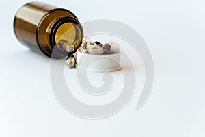 Medicine and pills. Medicines on a white background close-up. Brown glass bucket with capsules inside on a white