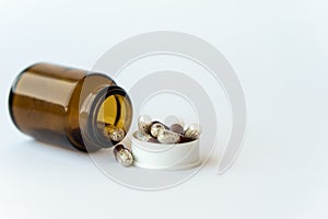 Medicine and pills. Medicines on a white background close-up. Brown glass bucket with capsules inside on a white