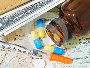 Medicine pills and money on map for travel