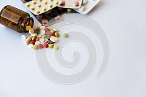 Medicine and pills. Multi-colored medicines on a white background close-up. Brown glass bucket and tablets with pills on