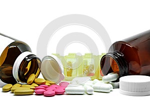 Medicine pills, vitamins, bottles and box on white background with copy space
