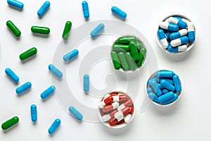 Medicine pills on white background, top view. Heap of dietary supplements, various colorful vitamins, assorted pharmaceutical