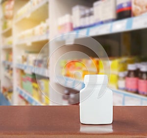 Medicine plastic bottle on table with pharmacy