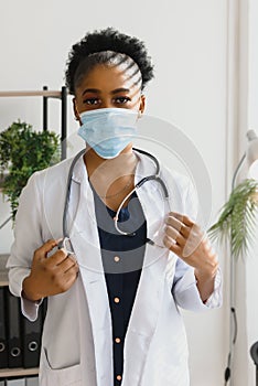 medicine, profession and healthcare concept - african american female doctor or scientist in protective facial mask in