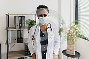 medicine, profession and healthcare concept - african american female doctor or scientist in protective facial mask in