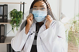 medicine, profession and healthcare concept - african american female doctor or scientist in protective facial mask in