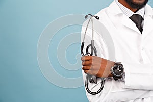 Medicine, profession and healthcare concept. African american male doctor with stethoscope in white coat on blue background