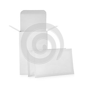 Medicine sachets and box on white background