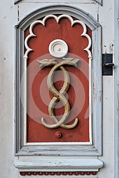 Medicine symbol of old pharmacy. Retro emblem of medicine - two snakes, caduceus, signboard on a wooden door