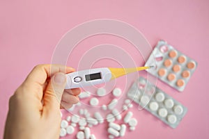 medicine tablets antibiotic pills on a pink background, cold and disease treatment