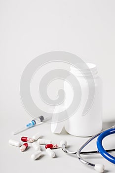 Medicine treatment concept. Various pills, stethoscope and syringes