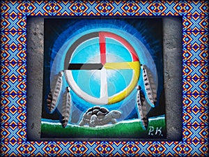 Medicine Wheel with feathers hanging and a land tortoise walking below. Native American canvas painting.