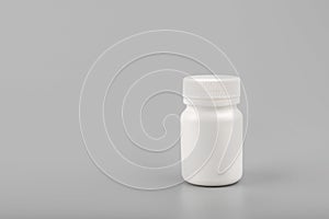 Medicine white pill bottle on grey background photo