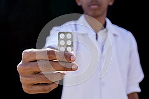 Medicine. Young doctor Holding Blister Pack With Pills In Hand. Health Care Concept. High Resolution