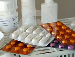 Medicines in blisters and plastic bottles on a shelf. Close-up. Background with medical drugs for pharmacies, industry