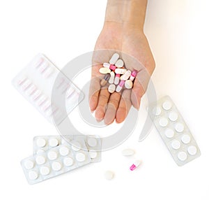 Medicines held in the palm with blister pack on the table