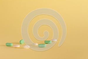 Medicines on a neutral yellow background. Drugs for legal use. Pharmaceutical industry. Concept of medication abuse. Medicines for