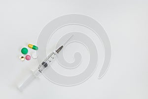 Medicines in a package and a syringe