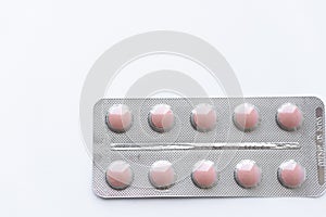 Medicines and pills. Multicolored medicines on a white background close-up. Plate with pink pills on a white background