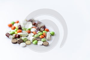 Medicines and pills. Multicolored medicines on a white background close-up. A slide of colored tablets on a white