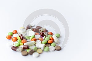 Medicines and pills. Multicolored medicines on a white background close-up. A slide of colored tablets on a white