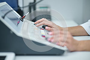 Medics hands touching buttons on equipment