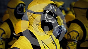 Medics in yellow protective suits lined up before the start of the working day. People in a bacteriological protection