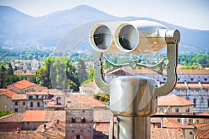 Medieaval italian city with binoculars on foregound photo