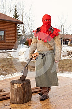 Medieval age executor with red hat and axe