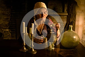 Medieval alchemist in kitchen