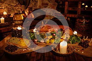 Medieval ancient kitchen table with typical food in royal castle. photo