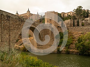 Medieval arch bridge on the Tagus River in Toledo City, Spain