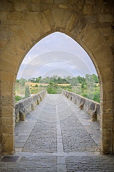 Medieval arch and the famous bridge in Puente la Reina, Spain