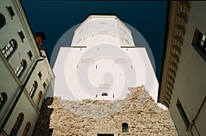 Medieval architecture. Ancient stone tower and buildings in Vyborg, Russia low angle view