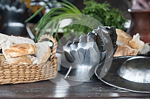 Medieval armor, detail of an ancient armor. Steel gloves on wooden background