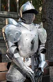 Medieval armor in front of a castle.
