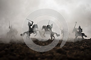 Medieval battle scene with cavalry and infantry. Silhouettes of figures as separate objects, fight between warriors on sunset