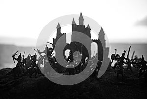 Medieval battle scene with cavalry and infantry. Silhouettes of figures as separate objects, fight between warriors on sunset