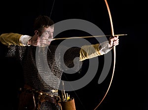 Medieval bowman. Studio shot photo