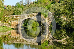 medieval bridge on the Arnoia river in the medieval town of Allariz photo