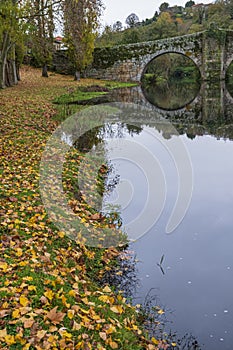 Medieval bridge and bank of Arnoia River. Fall in Allariz. Galicia, Spain. photo