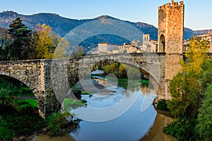 The Medieval Bridge of Besalu, at the first rays of the morning sun. Catalonia, Spain