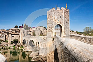 The medieval bridge of Besalu, Girona, Catalonia, Spain, with the village in the background