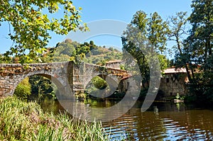 Medieval bridge over Arnoia river in Allariz Ourense, Spain photo