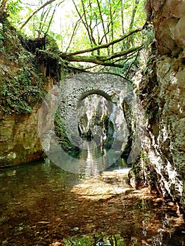 A medieval bridge on river Calore Irpino in Campania, italy photo