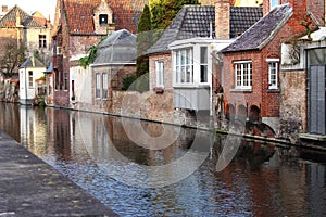 Medieval building facades on river canals in old town Brugge Bruges, Belgium. Vintage houses with wooden door and windows.