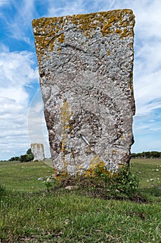 Medieval burial stone standing on a green field