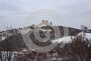 Medieval castle of Csesznek on the snowy hill photo