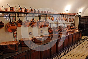 Medieval castle kitchen with old copperware.