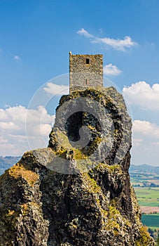 Medieval castle tower in the top of the rocky hillside